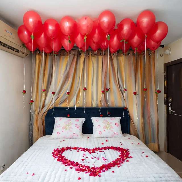 Elegant Romantic Bedroom Decorated With Rose Petals And Balloons